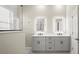 Bathroom featuring a double vanity, modern mirrors, and a walk-in shower at 13352 Creekside Ln, Port Charlotte, FL 33953