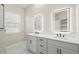 Modern bathroom with double sinks, sleek cabinetry, and illuminated mirrors at 13352 Creekside Ln, Port Charlotte, FL 33953