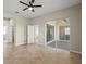 Spacious bedroom with tile flooring, ceiling fan, and sliding glass doors to the lanai at 13352 Creekside Ln, Port Charlotte, FL 33953