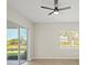 Bright room with tile flooring, a ceiling fan, and sliding glass doors to the outside at 13352 Creekside Ln, Port Charlotte, FL 33953