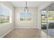 Well-lit dining area with large windows and sliding glass doors offering views of the outdoors at 13352 Creekside Ln, Port Charlotte, FL 33953