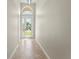Light-filled foyer with tile flooring and an etched glass front door with transom window at 13352 Creekside Ln, Port Charlotte, FL 33953