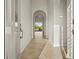 Open foyer with arched doorways, tile flooring, and a view of the backyard through the archway at 13352 Creekside Ln, Port Charlotte, FL 33953