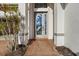Detailed front door with etched glass, brick walkway, and decorative plants creating curb appeal at 13352 Creekside Ln, Port Charlotte, FL 33953