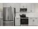 Kitchen featuring stainless appliances, white cabinets, and granite countertops at 13352 Creekside Ln, Port Charlotte, FL 33953