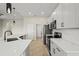 Modern kitchen with a gray color scheme, stainless appliances, and a white countertop at 13352 Creekside Ln, Port Charlotte, FL 33953