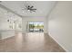 Spacious room with tiled floors, fan, and sliding glass doors to a screened patio at 13352 Creekside Ln, Port Charlotte, FL 33953