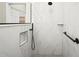 Modern shower featuring marble tile, matte black fixtures, and convenient recessed shelf at 13352 Creekside Ln, Port Charlotte, FL 33953