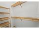 Bright walk-in closet with wood shelving providing substantial storage and organization at 13352 Creekside Ln, Port Charlotte, FL 33953