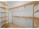 Bright walk-in closet featuring wood shelving and ample storage space for an organized wardrobe at 13352 Creekside Ln, Port Charlotte, FL 33953