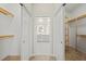 Open walk-in closet, equipped with wooden shelving on both sides at 13352 Creekside Ln, Port Charlotte, FL 33953