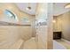 Bright bathroom featuring a glass shower, neutral tile, and beautiful granite countertops at 1341 Pine Siskin Dr, Punta Gorda, FL 33950