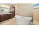 Bright bathroom featuring a soaking tub, dual sinks with granite countertops and beautiful cabinets at 1341 Pine Siskin Dr, Punta Gorda, FL 33950
