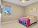 This bedroom features a large window, a ceiling fan, and bright walls at 1341 Pine Siskin Dr, Punta Gorda, FL 33950