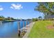 Long concrete dock along a canal with boat lift and ladder at 1341 Pine Siskin Dr, Punta Gorda, FL 33950