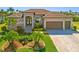 Charming single-story home with a well-manicured lawn and a two-car garage at 1341 Pine Siskin Dr, Punta Gorda, FL 33950