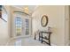Inviting foyer with tile flooring, double doors, and decorative console table with accessories at 1341 Pine Siskin Dr, Punta Gorda, FL 33950