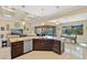 Open-concept kitchen with a large island, stainless steel appliances, and seamless flow into the living and dining areas at 1341 Pine Siskin Dr, Punta Gorda, FL 33950