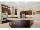 Stunning kitchen features a large granite island, stainless steel appliances, and dark wood cabinetry at 1341 Pine Siskin Dr, Punta Gorda, FL 33950