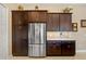 Modern kitchen with stainless steel refrigerator and stylish dark wood cabinets for ample storage at 1341 Pine Siskin Dr, Punta Gorda, FL 33950