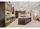 Bright kitchen with stainless steel appliances, dark wood cabinets, and an oversized island with counter seating at 1341 Pine Siskin Dr, Punta Gorda, FL 33950