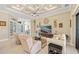 Spacious living room with tray ceiling, tile floors, and large TV for entertainment at 1341 Pine Siskin Dr, Punta Gorda, FL 33950