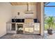 Outdoor kitchen features stainless steel appliances, a grill, and a wine cooler at 1341 Pine Siskin Dr, Punta Gorda, FL 33950