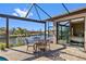 Relaxing screened lanai features a table for four overlooking a beautiful waterfront canal at 1341 Pine Siskin Dr, Punta Gorda, FL 33950