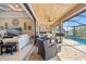 This covered patio features a water view, in ground pool, ceiling fan and seating at 1341 Pine Siskin Dr, Punta Gorda, FL 33950
