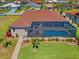 Aerial view of private screened pool with lush landscaping on a beautiful property at 1341 Pine Siskin Dr, Punta Gorda, FL 33950