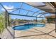 Relaxing pool with a screened enclosure and open-air patio overlooking the canal at 1341 Pine Siskin Dr, Punta Gorda, FL 33950