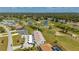 Aerial view of the condo building on a golf course with lush green fairways and trees in the background at 1408 San Cristobal Ave # 4, Punta Gorda, FL 33983