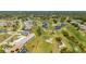 This aerial showcases the condo's golf course view, lush green grass, and natural landscaping at 1408 San Cristobal Ave # 4, Punta Gorda, FL 33983
