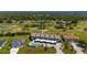 Aerial view of condo community featuring a view of a golf course, community pool, and convenient carports at 1408 San Cristobal Ave # 4, Punta Gorda, FL 33983