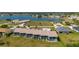 A condo aerial view in a serene neighborhood with lush green scenery, lake and a pool in view at 1408 San Cristobal Ave # 4, Punta Gorda, FL 33983