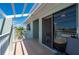 A covered balcony with access to the interior through sliding glass doors and views of the community at 1408 San Cristobal Ave # 4, Punta Gorda, FL 33983
