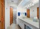 Bright bathroom with double doors, vanity, sink, and shower at 1408 San Cristobal Ave # 4, Punta Gorda, FL 33983