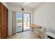 Bright dining area with table and access to the balcony through sliding glass doors at 1408 San Cristobal Ave # 4, Punta Gorda, FL 33983
