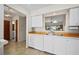 Well-lit kitchen with sleek white cabinetry, wood countertops, and a convenient pass-through to the living area at 1408 San Cristobal Ave # 4, Punta Gorda, FL 33983