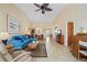 Comfortable living room with tiled floors features a blue couch, lanai access and a dining area at 1408 San Cristobal Ave # 4, Punta Gorda, FL 33983