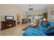 Comfortable living room with access to lanai, and a peek into the bedroom offers a glimpse of relaxation at 1408 San Cristobal Ave # 4, Punta Gorda, FL 33983