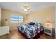 Bright bedroom featuring a ceiling fan, dresser, and windows with a view at 1408 San Cristobal Ave # 4, Punta Gorda, FL 33983