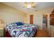 Main bedroom featuring a ceiling fan, a view from the window, and hardwood flooring at 1408 San Cristobal Ave # 4, Punta Gorda, FL 33983