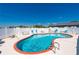 An in-ground pool surrounded by a white fence with patio furniture and lounge chairs at 1408 San Cristobal Ave # 4, Punta Gorda, FL 33983