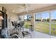 Enclosed sunroom featuring large windows, tiled floors, and a ceiling fan at 1408 San Cristobal Ave # 4, Punta Gorda, FL 33983