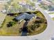 Aerial view of a property with well-maintained landscaping, mature trees, and clearly defined boundary lines at 146 Francis Ne Dr, Port Charlotte, FL 33952
