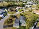 Birds-eye view of home with mature trees, convenient circular driveway, and beautifully manicured lawn at 146 Francis Ne Dr, Port Charlotte, FL 33952