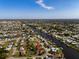 Aerial view of a waterfront neighborhood featuring cozy homes, canals, and mature trees at 146 Francis Ne Dr, Port Charlotte, FL 33952