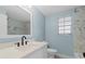 The bathroom offers a white vanity, tile, and a window at 146 Francis Ne Dr, Port Charlotte, FL 33952