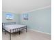 Well-lit bedroom with tile flooring and two windows overlooking the property at 146 Francis Ne Dr, Port Charlotte, FL 33952